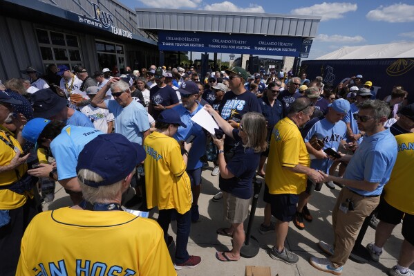 Fans pose for photos in Monument Park at Geroge M. Steinbrenner Field during a spring training baseball game between the Minnesota Twins and the New York Yankees, Thursday, March 6, 2025, in Tampa, Fla. (AP Photo/Chris O'Meara)