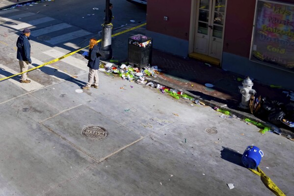 Members of the FBI and a bomb squad detonated a suspicious package from the blue cooler, bottom right, damaging a doorway according to an eyewitness at Bourbon Street near Toulouse Street during the investigation of truck crashing into pedestrians on Bourbon Street in the French Quarter in New Orleans, Wednesday, Jan. 1, 2025. (AP Photo/Matthew Hinton)