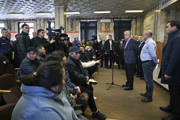 FILE - In this photo released by Kazakhstan's Presidential Press Office, Kazakh President Kassym-Jomart Tokayev, third right, expresses condolences to the families and friends of the miners who died in the fire in Karaganda, Kazakhstan, Saturday, Oct. 28, 2023. (Kazakhstan's Presidential Press Office via AP, File)