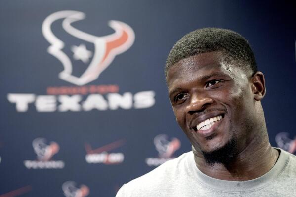 FILE - Houston Texans wide receiver Andre Johnson smiles as he answers a question after reporting for NFL football training camp, July 25, 2014, in Houston. Johnson is among 26 modern day semifinalists for the Pro Football Hall of Fame's class of 2022. (AP Photo/David J. Phillip, file)