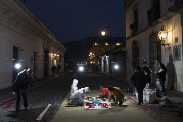 Devotees create a sawdust carpet in preparation for a Holy Week procession in Antigua, Guatemala, on Good Friday, March 29, 2024. (AP Photo/Moises Castillo)