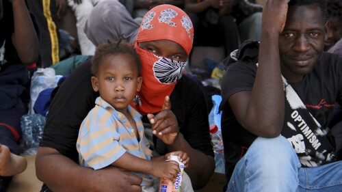 Migrants sit during a gathering in Sfax, Tunisia's eastern coast, Friday, July 7, 2023. Tensions spiked dangerously in a Tunisian port city this week after three migrants were detained in the death of a local man, and there were reports of retaliation against Black foreigners and accounts of mass expulsions and alleged assaults by security forces. (AP Photo)