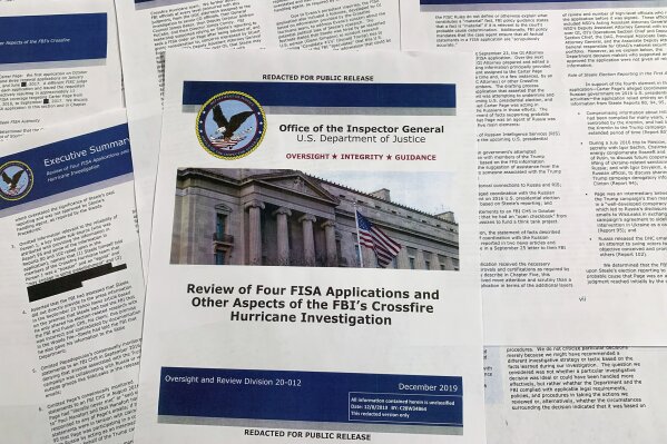 The report issued by the Department of Justice inspector general is photographed in Washington, Monday, Dec. 9, 2019. The report on the origins of the Russia probe found no evidence of political bias, despite performance failures. (AP Photo/Jon Elswick)