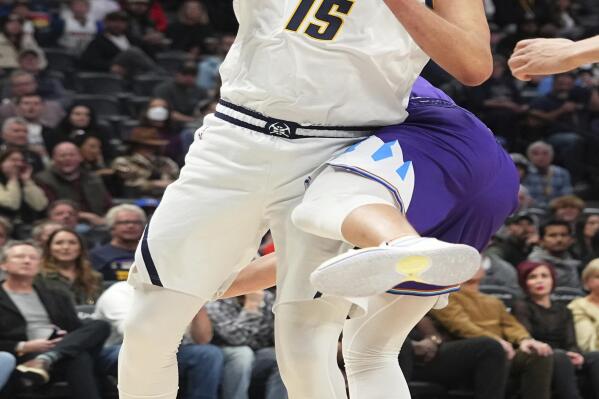 Denver Nuggets center Nikola Jokic (15) grabs a rebound against the Utah Jazz during the first quarter of an NBA basketball game Friday, Oct. 28, 2022, in Denver. (AP Photo/Jack Dempsey)