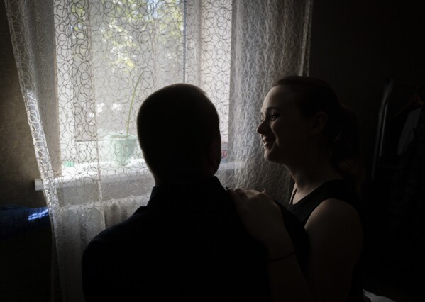 Vladislava Ryabets, right, turns towards his blind husband Ivan Soroka, left, during the second day of their wedding in the outskirt of Kyiv, Ukraine on Sunday, Sept. 10, 2023. (AP Photo/Bela Szandelszky)