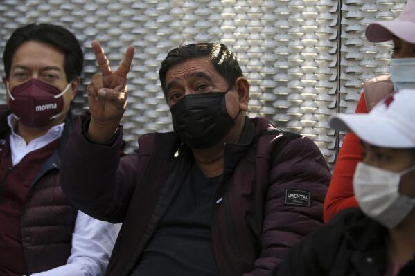 Felix Salgado flashes a V hand sign during a protest outside the Electoral Tribunal to demand a reversal of the decision to remove him as a gubernatorial candidate, in Mexico City, Wednesday, April 7, 2021. Mexico's election agency withdrew the ballot registration of Salgado who was nominated by Mexico's ruling Morena party despite accusations of rape against him, saying he failed to report the money he spent during the primary process. (AP Photo/Fernando Llano)