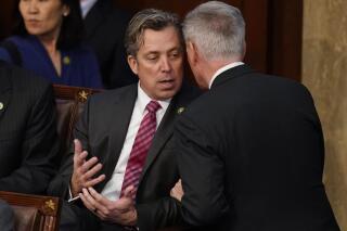 FILE - Rep. Andy Ogles, R-Tenn., left, talks with Rep. Kevin McCarthy, R-Calif., during the eighth round of voting in the House chamber as the House meets for the third day to elect a speaker and convene the 118th Congress in Washington on Jan. 5, 2023. Ogles said in a statement Sunday, Feb. 26, that he was “mistaken” when he said he graduated with an international relations degree after a local news outlet raised questions over whether the Republican had embellished his education. (AP Photo/Alex Brandon, File)
