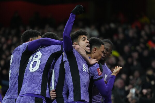 Liverpool's Luis Diaz, center, celebrates with teammates his side's first goal during the English FA Cup soccer match between Arsenal and Liverpool at Emirates stadium in London, Sunday, Jan. 7, 2024. The opening goal was an own goal by Arsenal's Jakub Kiwior. (AP Photo/Kirsty Wigglesworth)