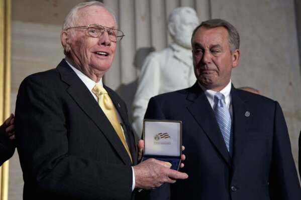 FILE - In this Nov. 16, 2011 file photo, House Speaker John Boehner of Ohio, right, presents a Congressional Gold Medal to Neil Armstrong during a ceremony to honor astronauts on Capitol Hill in Washington. Court documents show that an Ohio hospital paid the estate of astronaut Armstrong $6 million to settle allegations that post-surgical complications led to his 2012 death. The 2014 settlement went to 10 family members, including Armstrong's two sons, sister, brother and six grandchildren, according to documents filed with the Hamilton County Probate Court in Cincinnati which were publicly available on Tuesday, July 23, 2019. (AP Photo/Evan Vucci, File)