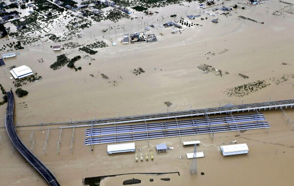 Rows of Japan's bullet trains, parked in a facility, sit in a pool of water in Nagano, central Japan, after Typhoon Hagibis hit the city, Sunday, Oct. 13, 2019. Rescue efforts for people stranded in flooded areas are in full force after a powerful typhoon dashed heavy rainfall and winds through a widespread area of Japan, including Tokyo.(Yohei Kanasashi/Kyodo News via AP)