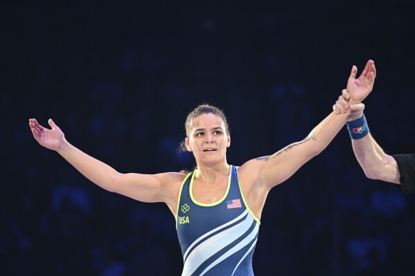 Kayla Miracle raises her arms after winning a 62-kilogram bout in the finals at the U.S. Olympic wrestling trials in State College, Pa., Saturday, April 20, 2024. (AP Photo/Aidan Conrad)
