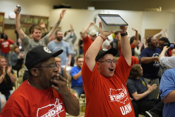 Volkswagen automobile plant employee Duke Brandon, right, celebrates after employees voted to join the UAW union Friday, April 19, 2024, in Chattanooga, Tenn. (AP Photo/George Walker IV)