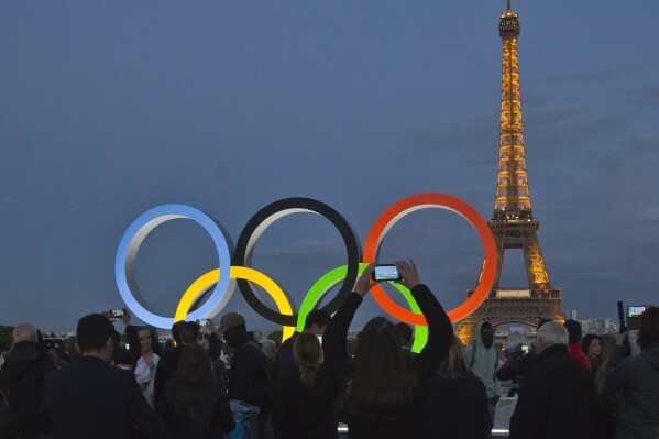 FILE - The Olympic rings are set up on Trocadero plaza that overlooks the Eiffel Tower, a day after the official announcement that the 2024 Summer Olympic Games will be in the French capital, in Paris, Thursday, Sept. 14, 2017. The organizers of the Paris Games say the Olympic rings will be displayed on the Eiffel Tower. The five-ring creation is 29-meters long and 15-meter high, made entirely of recycled steel, the Games organizers said in a statement Monday April, 8, 2024. (AP Photo//Michel Euler, File)