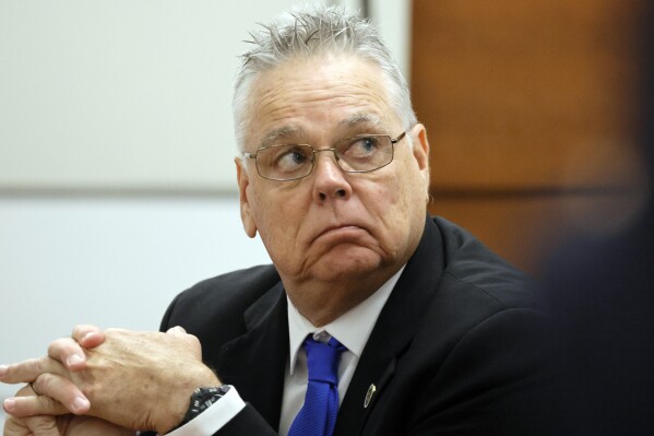 Former MSD School Resource Officer Scot Peterson sits at the defense table during closing arguments in his trial, Monday, June 26, 2023, at the Broward County Courthouse in Fort Lauderdale, Fla. Peterson is accused of failing to confront the shooter who murdered 14 students and three staff members at a Parkland high school five years ago. (Amy Beth Bennett/South Florida Sun-Sentinel via AP, Pool)