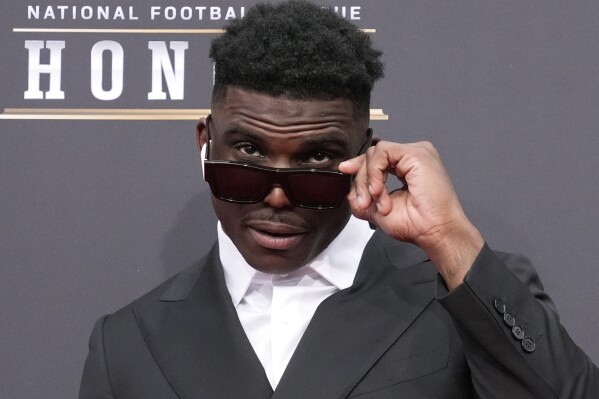 Tyreek Hill of the Miami Dolphins poses on the red carpet at the NFL Honors award show ahead of the Super Bowl 58 football game Thursday, Feb. 8, 2024, in Las Vegas. (AP Photo/Charlie Riedel)