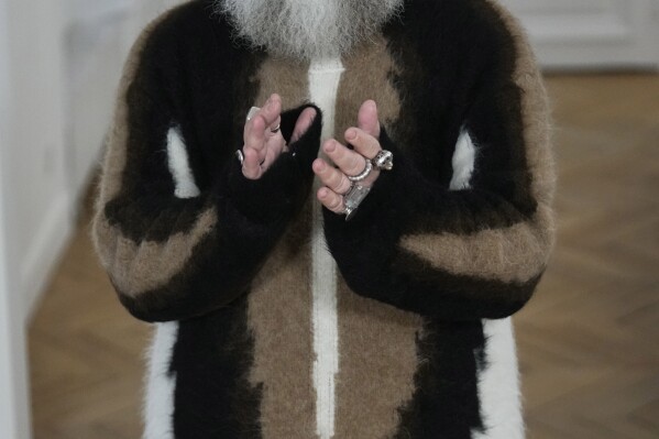 Designer Walter van Beirendonck applauds after the presentation of his Menswear ready-to-wear Fall-Winter 2024-2025 collection in Paris Wednesday, Jan. 17, 2024 in Paris. (AP Photo/Michel Euler)