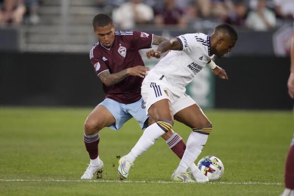 Colorado Rapids defender Lucas Esteves, left, vie for control of the ball against LA Galaxy forward Douglas Costa during the second half of an MLS soccer match Saturday, July 16, 2022, in Commerce City, Colo. (AP Photo/David Zalubowski)