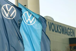 FILE - In this file photo dated Thursday, April 23, 2020, company logo flags wave in front of a Volkswagen factory building in Zwickau, Germany.  Volkswagen will present its final financial statements for the 2020 financial year, on Tuesday March 16, 2021. (AP Photo/Jens Meyer, FILE)
