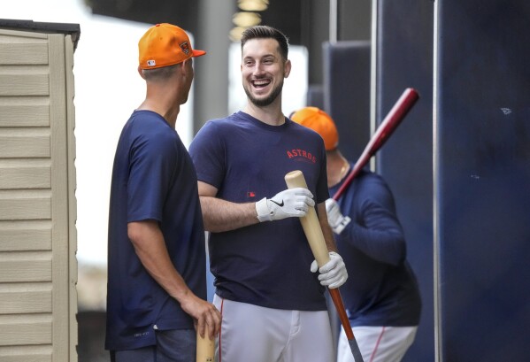 Houston Astros Grae Kessinger and Kyle Tucker talk in the batting cages during workouts for Astros pitchers and catchers at CACTI Park of the Palm Beaches, Sunday, Feb. 18, 2024, in West Palm Beach, Fla. (Karen Warren/Houston Chronicle via AP)