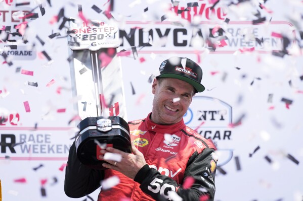 Will Power celebrates after winning an IndyCar auto race, Sunday, July 14, 2024, at Iowa Speedway in Newton, Iowa. (ĢӰԺ Photo/Charlie Neibergall)