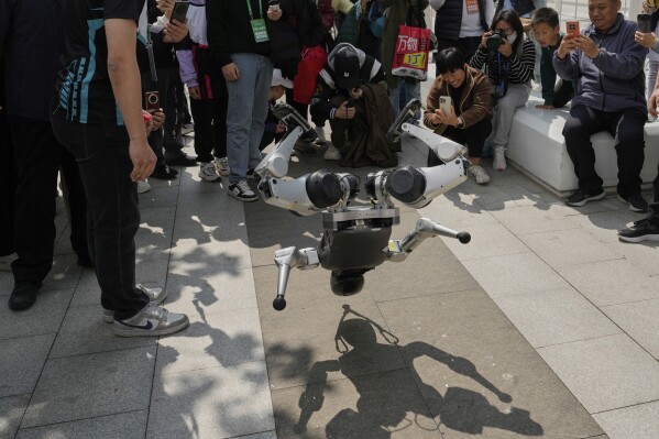 A robot demonstrates a backflip after the Humanoid Robot Half-Marathon held in Beijing on Saturday, April 19, 2025. (AP Photo/Ng Han Guan)