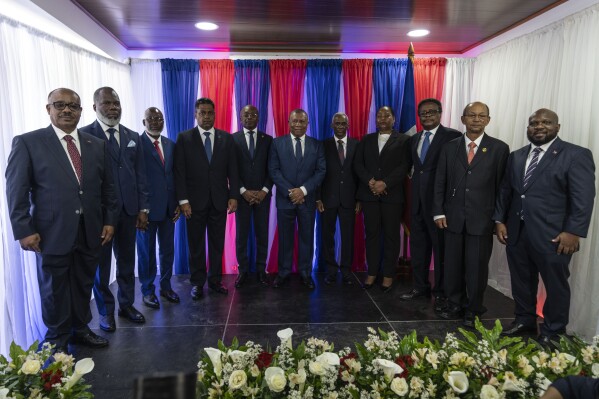 IDENTIFIES TRANSITIONAL COUNCIL MEMBERS - Ex-senator Louis Gerald Gilles, from left to right, pastor Frinel Joseph, barrister Emmanuel Vertilaire, businessman Laurent Saint-Cyr, interim Prime Minister Michel Patrick Boisvert, Judge Jean Joseph Lebrun, who is not a member of the council, former senate president Edgard Leblanc, Regine Abraham, former central bank governor Fritz Alphonse Jean, former diplomat Leslie Voltaire and former ambassador to the Dominican Republic Smith Augustin, pose for a group photo during an installation ceremony, in Port-au-Prince, Haiti, Thursday, April 25, 2024. (AP Photo/Ramon Espinosa)