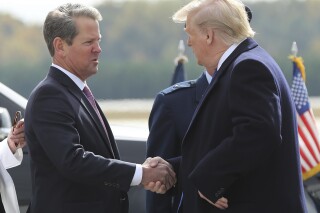 FILE - Georgia Gov. Brian Kemp, left, greets President Donald Trump as he arrives at Dobbins Air Reserve Base, Nov. 8, 2019, in Marietta, Ga. (Curtis Compton/Atlanta Journal-Constitution via AP, File)