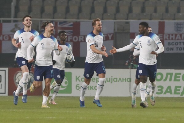 England's Harry Kane, centre, celebrates with teammates after North Macedonia's Jani Atanasov scored an own goal during the Euro 2024 group C qualifying soccer match between North Macedonia and England at National Arena Todor Proeski in Skopje, North Macedonia, Monday, Nov. 20, 2023. (AP Photo/Boris Grdanoski)