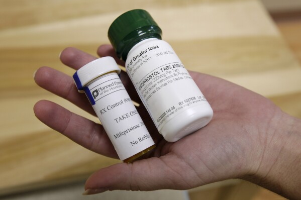 FILE - Bottles of abortion pills mifepristone, left, and misoprostol, right, at a clinic in Des Moines, Iowa, on Sept. 22, 2010. (AP Photo/Charlie Neibergall, File)