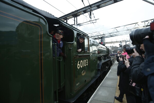 The Flying Scotsman, a historical locomotive, arrives at Kings Cross railway station in London to pick up passengers for its journey to York, Thursday, Feb. 25, 2016. Several people were injured after the Flying Scotsman, the historic steam locomotive, was involved in a “low speed” crash with another heritage train in the Scottish Highlands on Friday, Sept. 29, 2023. (AP Photo/Alastair Grant)