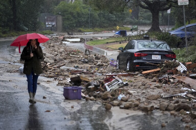 Mud and debris is strewn on Fryman Rd. during a rain storm, Monday Feb. 5, 2024, in Studio City Calif. The second of back-to-back atmospheric rivers took aim at Southern California, unleashing mudslides, flooding roadways and knocking out power as the soggy state braced for another day of heavy rains. (AP Photo/Marcio Jose Sanchez)