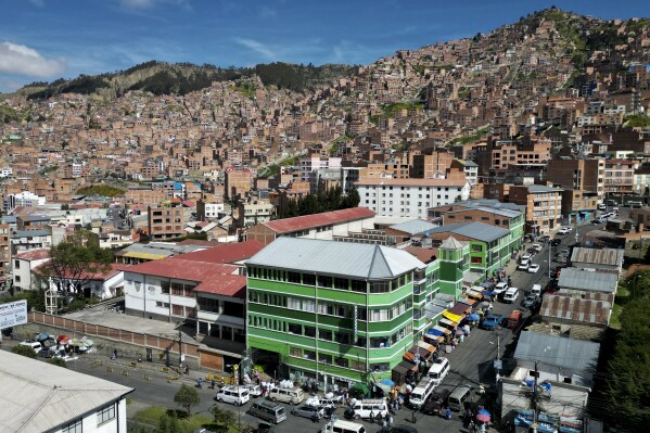 A legal coca leaf market stands on a street corner in La Paz, Bolivia, Thursday, April 18, 2024. Bolivia's government revived a years-long battle to get the UN to decriminalize the coca leaf, an effort to gain global recognition for its indigenous people.  traditions and expand its local market for coca-related products.  (AP Photo/Juan Karita)