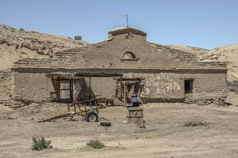 A destroyed fishing workshop sits near Muynak, Uzbekistan, Saturday, June 24, 2023. (AP Photo/Ebrahim Noroozi)