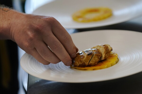 Chef Zach Tyndall prepares Good Meat's cultivated chicken at the Eat Just office in Alameda, Calif., Wednesday, June 14, 2023. The U.S. government is allowing the sale of chicken made from animal cells. California companies Upside Foods and Good Meat were granted permission on Wednesday, June 21, 2023 to sell their products by the Agriculture Department. Proponents say this “cultivated meat” is better for animals and the environment because livestock doesn’t need to be raised and killed to produce it. (AP Photo/Jeff Chiu)