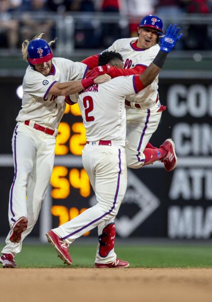 Philadelphia Phillies' Travis Jankowski, left, Jean Segura (2) and Ronald Torreyes, right, celebrate after the Phillieos defeated the New York Yankees 8-7 in 10 innings in a baseball game Saturday, June 12, 2021, in Philadelphia. (AP Photo/Laurence Kesterson)