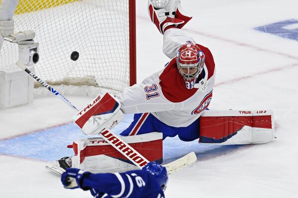 Montreal Canadiens goaltender Carey Price (31) makes a save on Toronto Maple Leafs forward Mitchell Marner (16) during the third period of Game 1 of an NHL hockey Stanley Cup first-round playoff series Thursday, May 20, 2021, in Toronto. (Frank Gunn/The Canadian Press via AP)