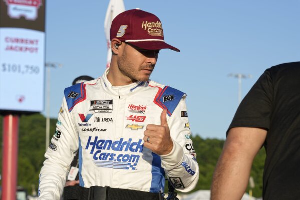 Kyle Larson gives a thumbs-up after arriving for the NASCAR All-Star auto race at North Wilkesboro Speedway in North Wilkesboro, N.C., Sunday, May 19, 2024. (AP Photo/Chuck Burton)