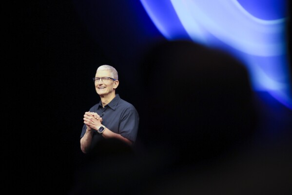 Apple CEO Tim Cook walks on the stage during an announcement of new products at Apple headquarters Monday, Sept. 9, 2024, in Cupertino, Calif. (AP Photo/Juliana Yamada)