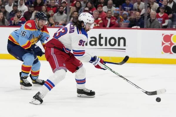 New York Rangers center Mika Zibanejad (93) prepares to shoot to score a goal as Florida Panthers center Aleksander Barkov (16) defends during the first period of an NHL hockey game, Sunday, Jan. 1, 2023, in Sunrise, Fla. (AP Photo/Lynne Sladky)