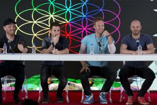 FILE - In this Friday, April 15, 2016 file photo, members of British band Coldplay, from left, Jonny Buckland, Guy Berryman, Chris Martin, and Will Champion, participate in a press conference at Foro Sol in Mexico City. The British band Coldplay has decided not to launch a global tour because of environmental concerns. Frontman Chris Martin told the BBC Thursday, Nov. 21, 2019 that the band is not going on tour to promote its latest album because it wants to take time to determine how a tour can be beneficial to the environment. (AP Photo/Rebecca Blackwell, file)
