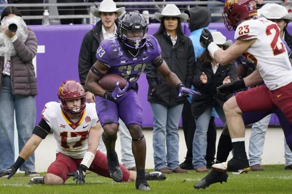 TCU running back Kendre Miller beats Iowa State defenders Beau Freyler (17) and Will McLaughlin on his way to score a touchdown during the first half of an NCAA college football game in Fort Worth, Texas, Saturday, Nov. 26, 2022. (AP Photo/LM Otero)