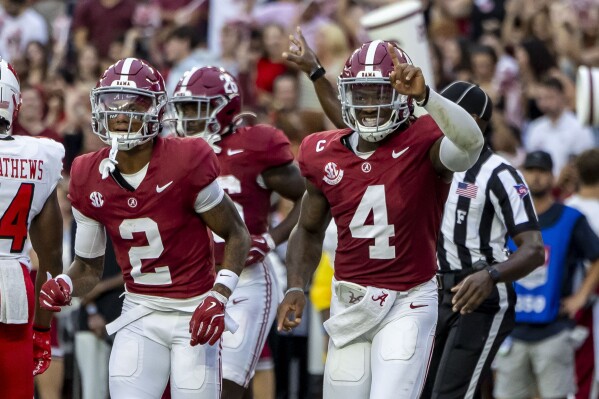 Alabama wide receiver Ryan Williams (2) and Alabama quarterback Jalen Milroe (4) celebrate after Milroe's touchdown run against Western Kentucky during the first half of an NCAA college football game, Saturday, Aug. 31, 2024, in Tuscaloosa, Ala. (AP Photo/Vasha Hunt)