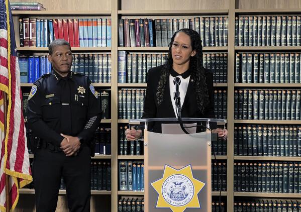 San Francisco District Attorney Brooke Jenkins addresses reporters at a news conference with Police Chief William Scott standing next to her on Monday, Oct. 31, 2022, in San Francisco. Jenkins announced state charges against David DePape, including attempted murder. DePape is accused of breaking into the home of House Speaker Nancy Pelosi and attacking her husband with a hammer.  (AP Photo/Terry Chea)