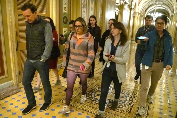 Sen. Chris Murphy, D-Conn., left, and Sen. Kyrsten Sinema, I-Ariz., arrive for closed-door negotiations on a border security deal at the Capitol, Sunday, Dec. 17, 2023, in Washington. Negotiators are rushing to reach a U.S. border security deal that would unlock President Joe Biden's request for billions of dollars worth in military aid for Ukraine and national security. (AP Photo/Mark Schiefelbein)