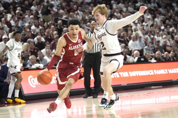 FILE - Alabama guard Jahvon Quinerly (5) drives past Texas A&M guard Hayden Hefner (2) during the second half of an NCAA college basketball game Saturday, March 4, 2023, in College Station, Texas. Quinerly announced his plans to leave the Crimson Tide Sunday night, June 25, on social media after opting to return instead of following teammates Brandon Miller, Noah Clowney and Charles Bediako into the NBA draft. (AP Photo/Sam Craft, File)