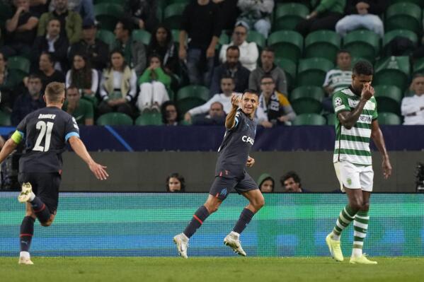 Marseille's Alexis Sanchez, center, celebrates after scoring his side's 2nd goal during a Champions League group D soccer match between Sporting CP and Olympique de Marseille at the Alvalade stadium in Lisbon, Wednesday, Oct. 12, 2022. (AP Photo/Armando Franca)