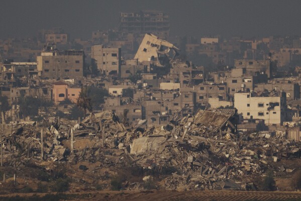 Destroyed buildings from Israeli airstrike are seen in the northern Gaza Strip, as seen from southern Israel, Thursday, Dec. 7, 2023. (AP Photo/Leo Correa)