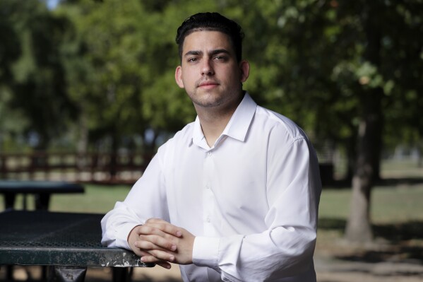 Felix Llerena, a Cuban immigrant and political activist now living in Texas, poses for a photo at Arthur Storey Park, Friday, Sept. 22, 2023, in Houston. (AP Photo/Michael Wyke)