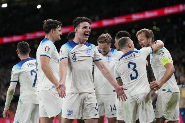 England's Declan Rice reacts after teammate Harry Kane, right, scored their third goal during the Euro 2024 group C qualifying soccer match between England and Italy at Wembley stadium in London, Tuesday, Oct. 17, 2023. (AP Photo/Kirsty Wigglesworth)