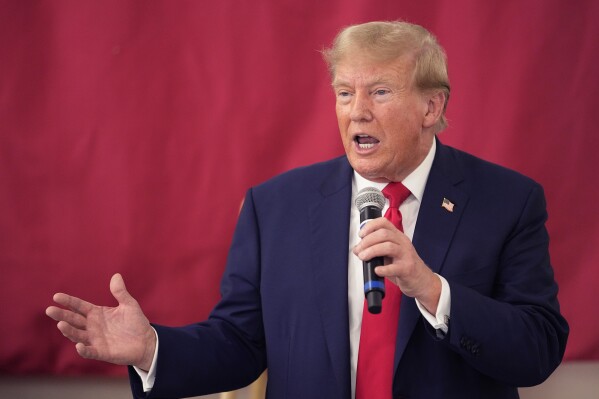 FILE - Republican presidential candidate and former President Donald Trump speaks to Texas state troopers and guardsmen at the South Texas International Airport, Nov. 19, 2023, in Edinburg, Texas. Trump's lawyers are arguing that he had a good faith basis to question the outcome of the 2020 election that he lost. A defense motion filed late Monday in federal court in Washington asserts that Trump was not obligated to accept at face value the judgments of government officials who found no widespread fraud in the election. (AP Photo/Eric Gay, File)